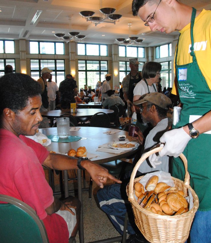 100830-N-5647H-054
BALTIMORE (Aug. 30, 2010) Airman Bryan Pickett, assigned to USS Constitution, serves bread to the community of the Daily Bread Soup Kitchen as part of Baltimore Navy Week. Baltimore Navy Week is one of 20 Navy Weeks planned across America this year. Navy Weeks show Americans the investment they have made in their Navy and increase awareness in cities that do not have a significant Navy presence. (U.S. Navy photo by Seaman Shannon S. Heavin/Released)